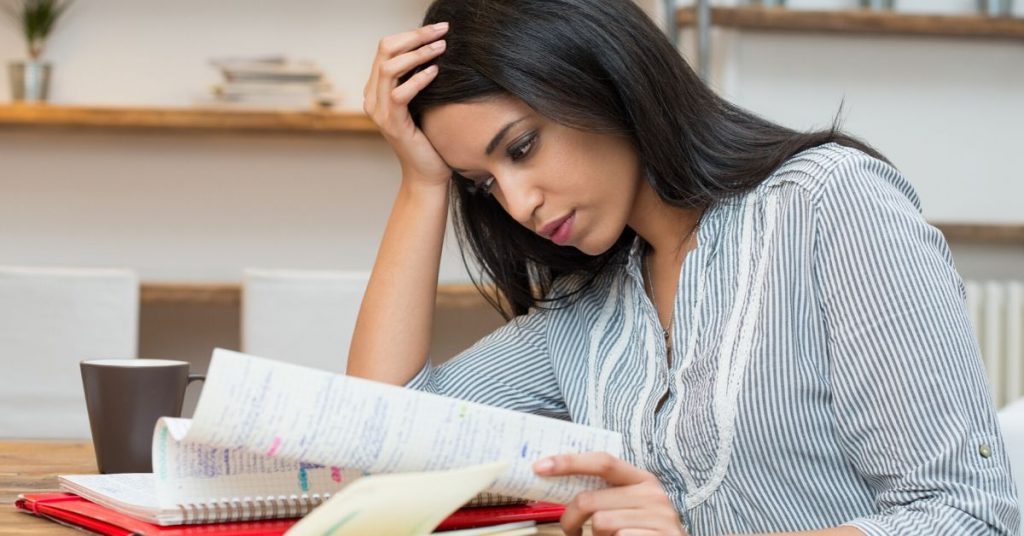 woman using CFA exam study tips to study on laptop computer for Level 1 CFA exam