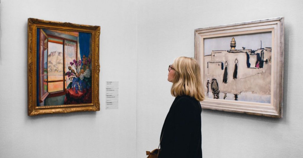 woman in art gallery wondering if she can pass the cfa exam