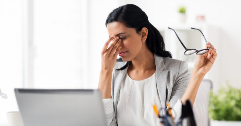 Woman straining her eyes while studying for the CFA Exam