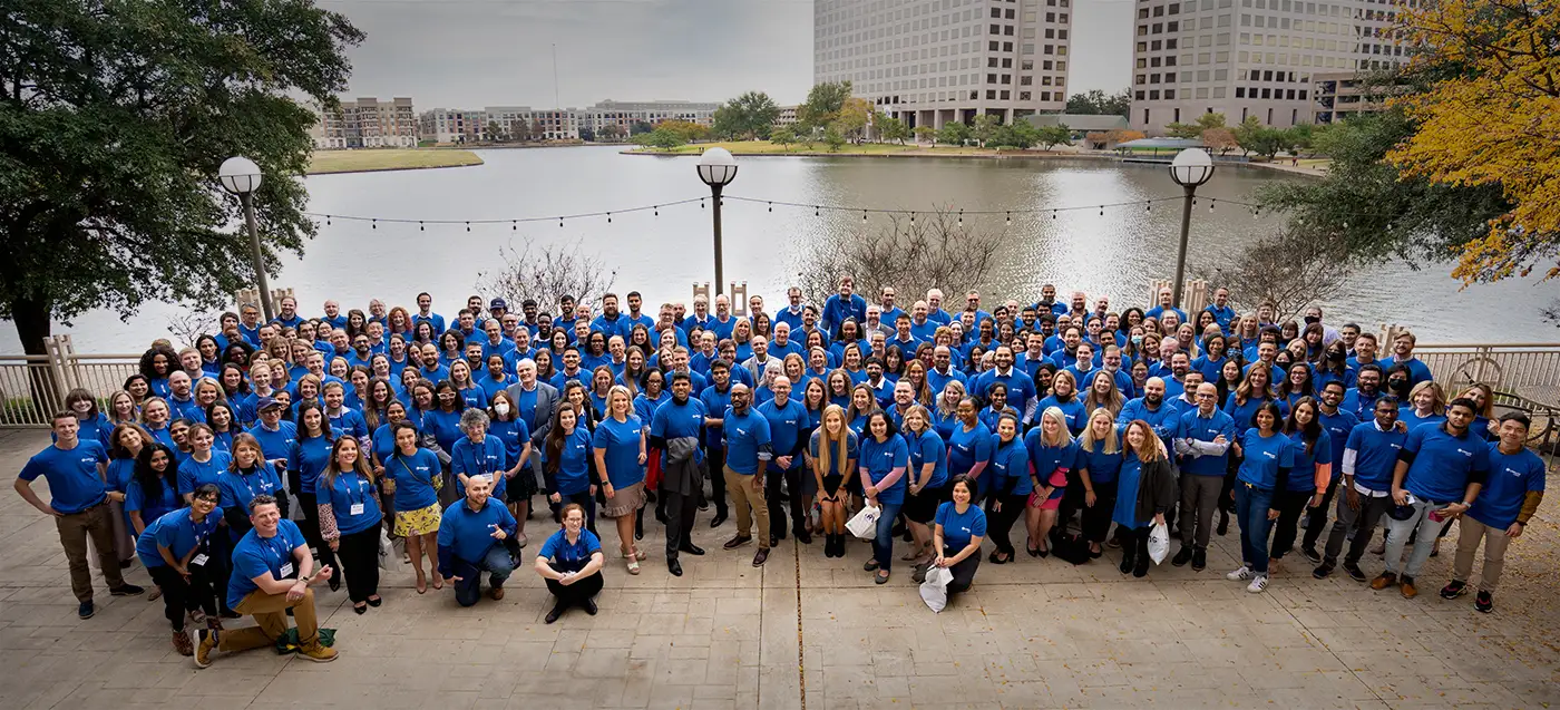 Showing a wide picture of the entire UWorld team in matching blue shirts.