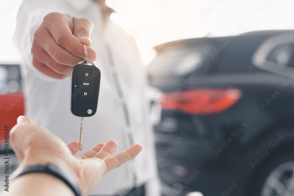 Man is handing keys over to a new car representing the “UWorld CFA test Drive”