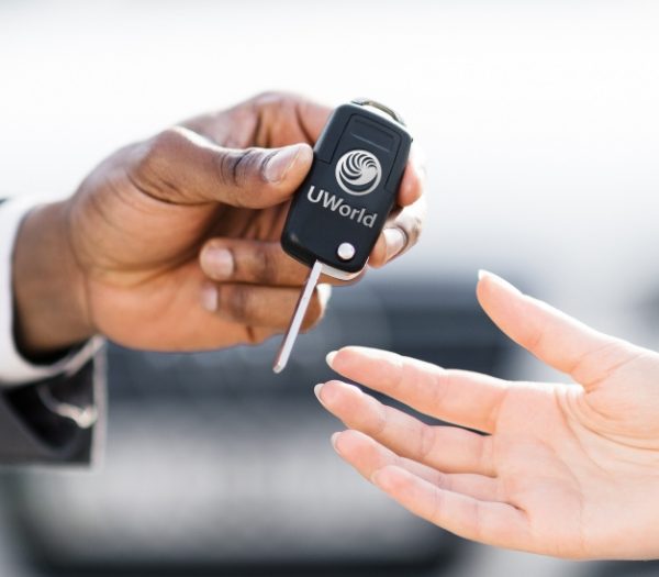 Man is handing keys over to a new car representing the “UWorld CFA exam prep test Drive”.