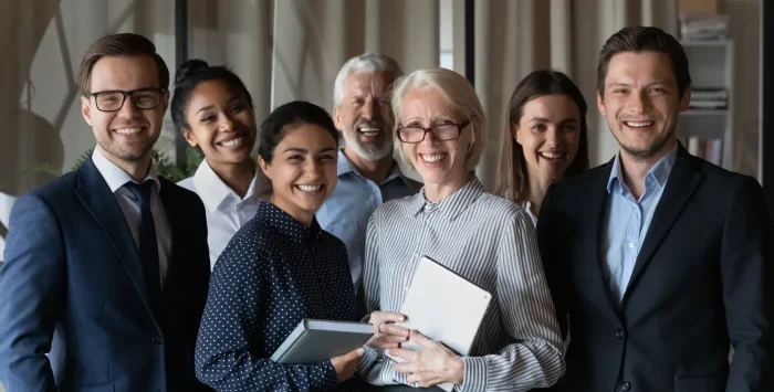 Group of Finance interns posing with the firm's job coordinator and professional supporters.
