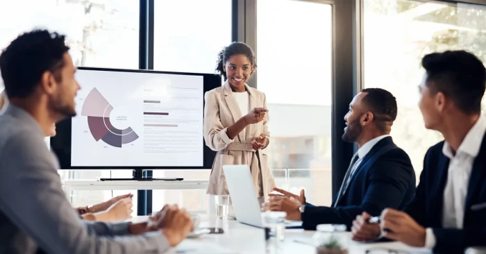 CFA professionals discussing whether the CFA designation is still worth it today during a presentation.