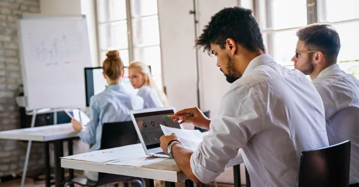 Focused students reviewing data and studying with the best CFA prep books for exam success..