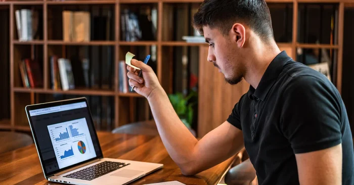 CFA candidate reviewing UWorld CFA exam charts and analytics in a library.