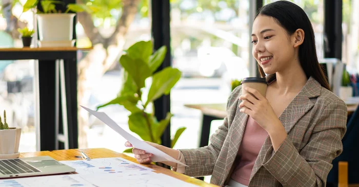 CFA charterholder reviewing finance reports in a modern workspace, exploring global industry demand.