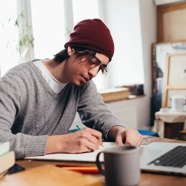 CFA candidate registering online and taking notes to avoid common exam mistakes.