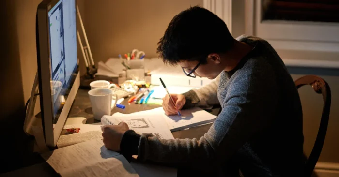 CFA candidate taking a CFA exam prep quiz with notes and study materials.