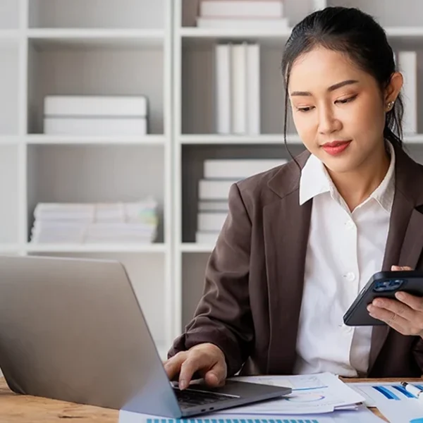 CFA charterholder working remotely while exploring job trends and opportunities on a laptop.