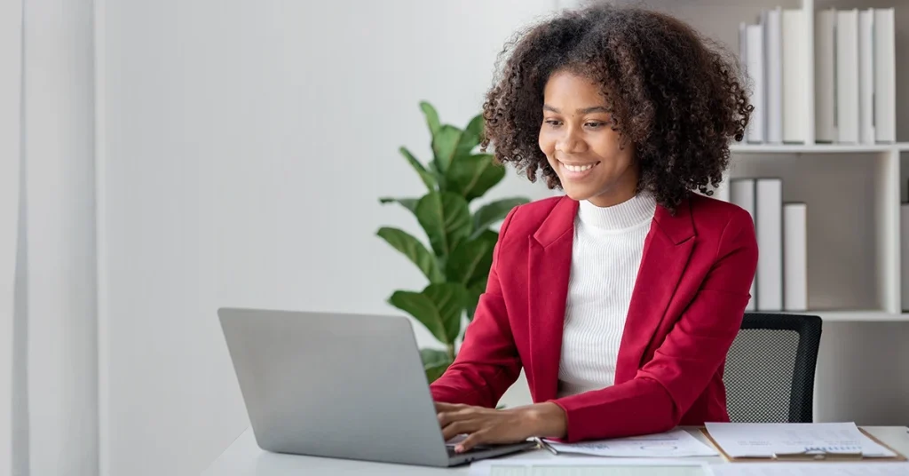CFA candidate studying digitally and comparing note-taking methods on a laptop.