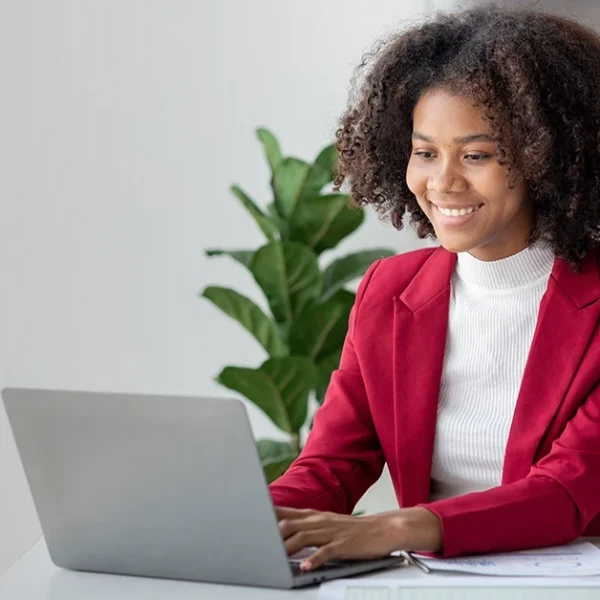 CFA candidate studying digitally and comparing note-taking methods on a laptop.