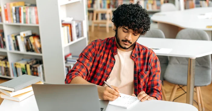 A candidate using CFA formula sheets to practice.